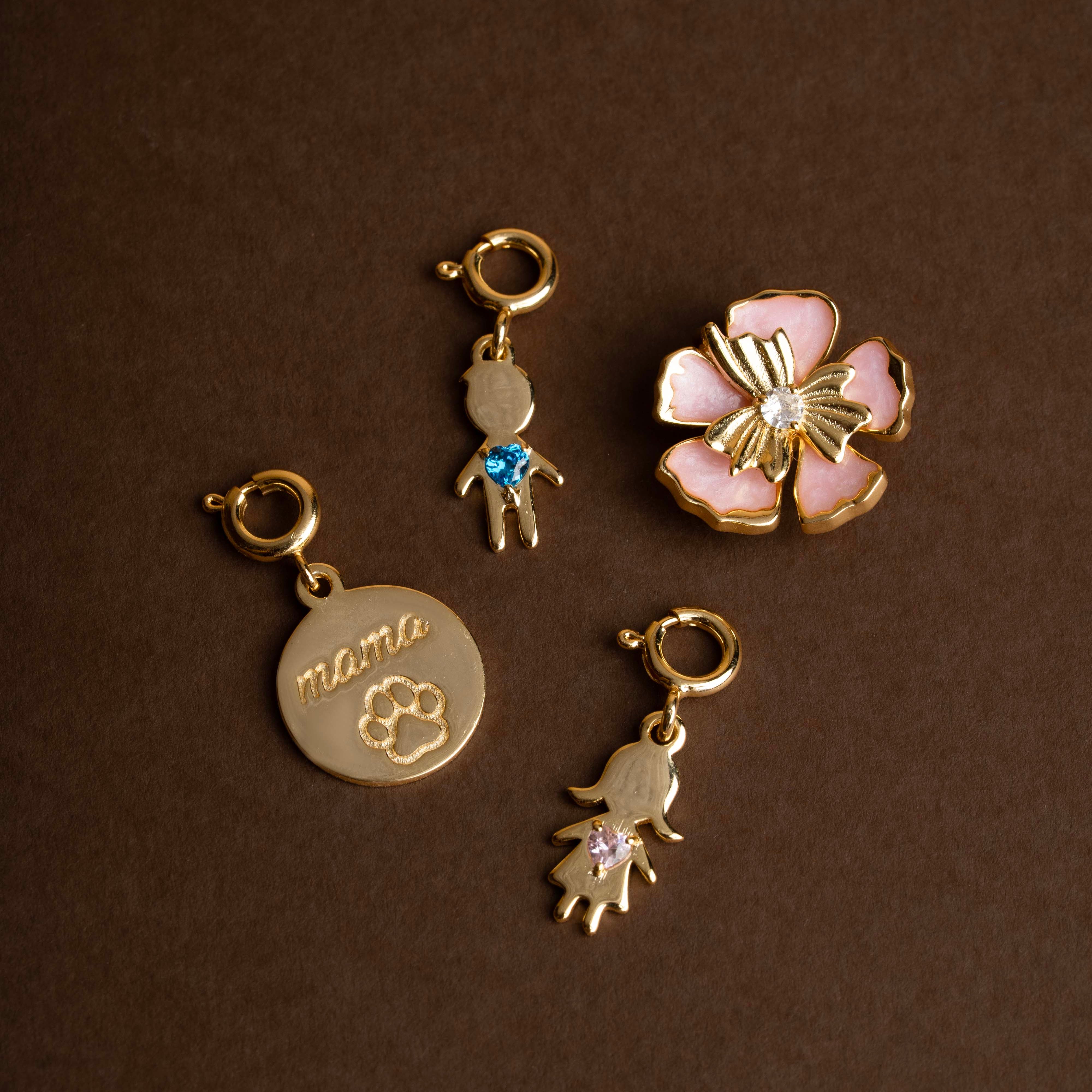 Set of gold charms on a brown background